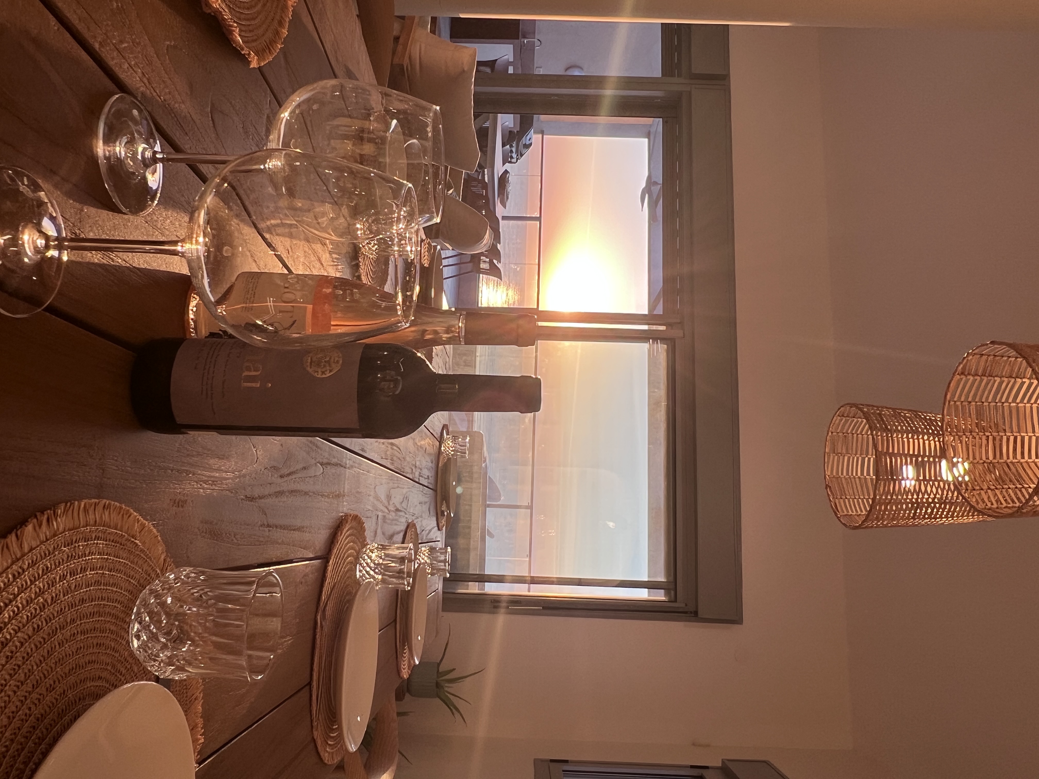 Sea view with wine glasses at sunset